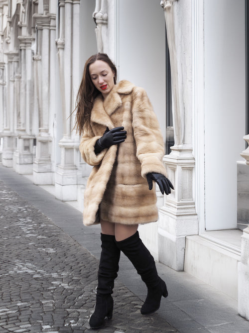 Walking pose in blond pastel mink fur coat stroller jacket, ideal for luxury fur outerwear and elegant street style.