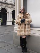 Model posing in blond pastel mink fur coat stroller jacket with gloves, perfect for luxury outerwear and cold-weather fashion.