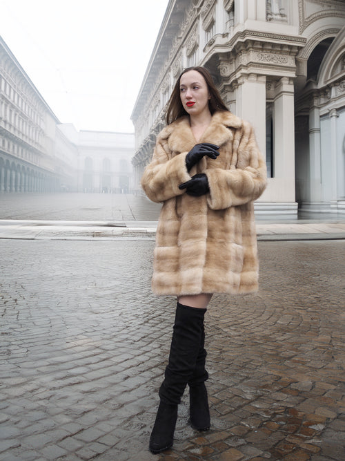 Blond pastel mink fur coat stroller jacket styled for city wear, offering timeless warmth and sophistication in winter fashion.