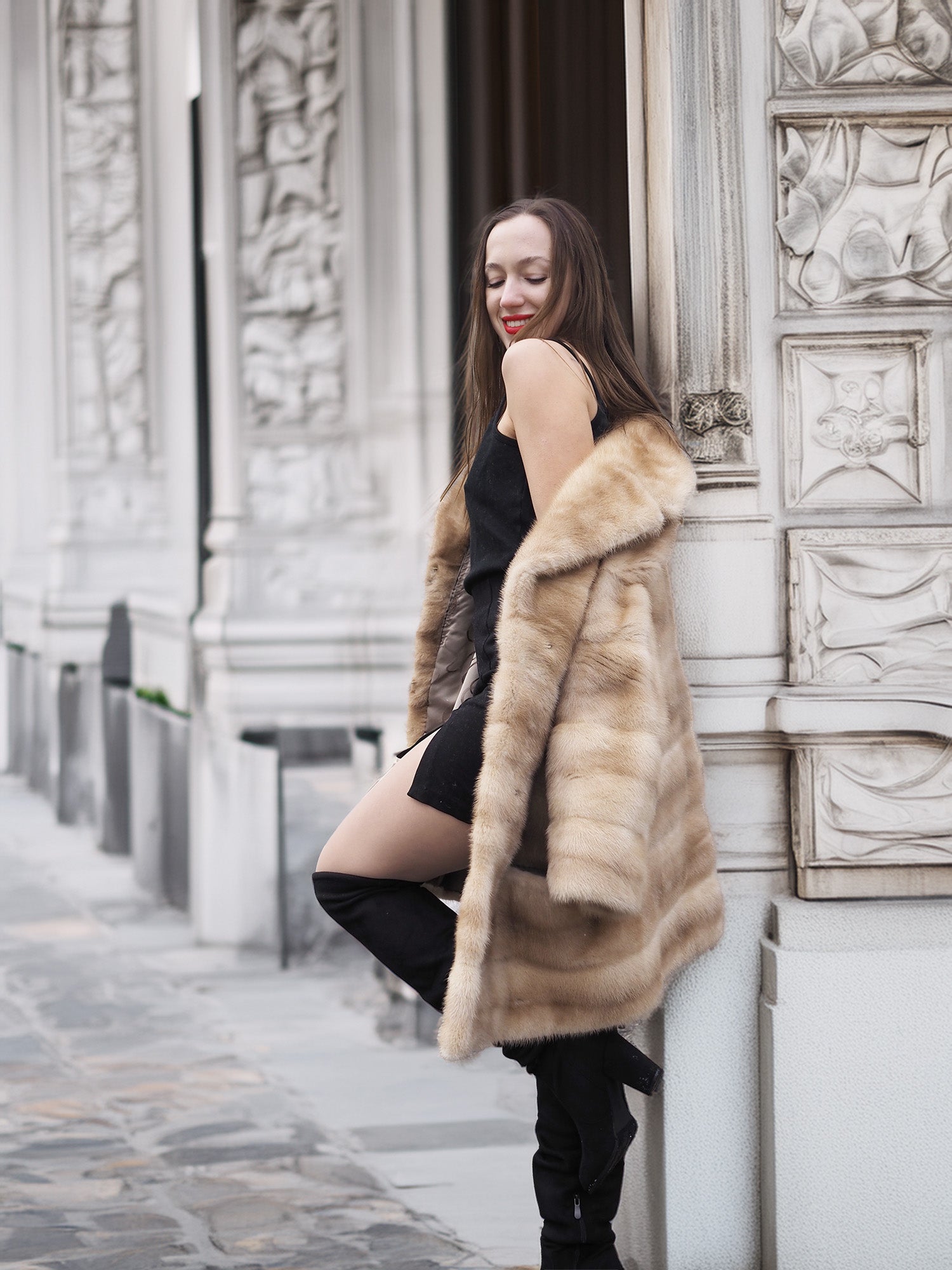 Chic blond pastel mink fur coat stroller jacket draped over shoulders, highlighting its soft texture and fashionable winter appeal.