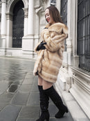 Blond pastel mink fur coat stroller jacket styled with black boots, perfect for elegant winter fashion and sustainable fur lovers.