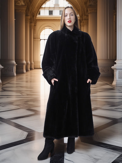Woman wearing a black fur coat in an elegant hallway