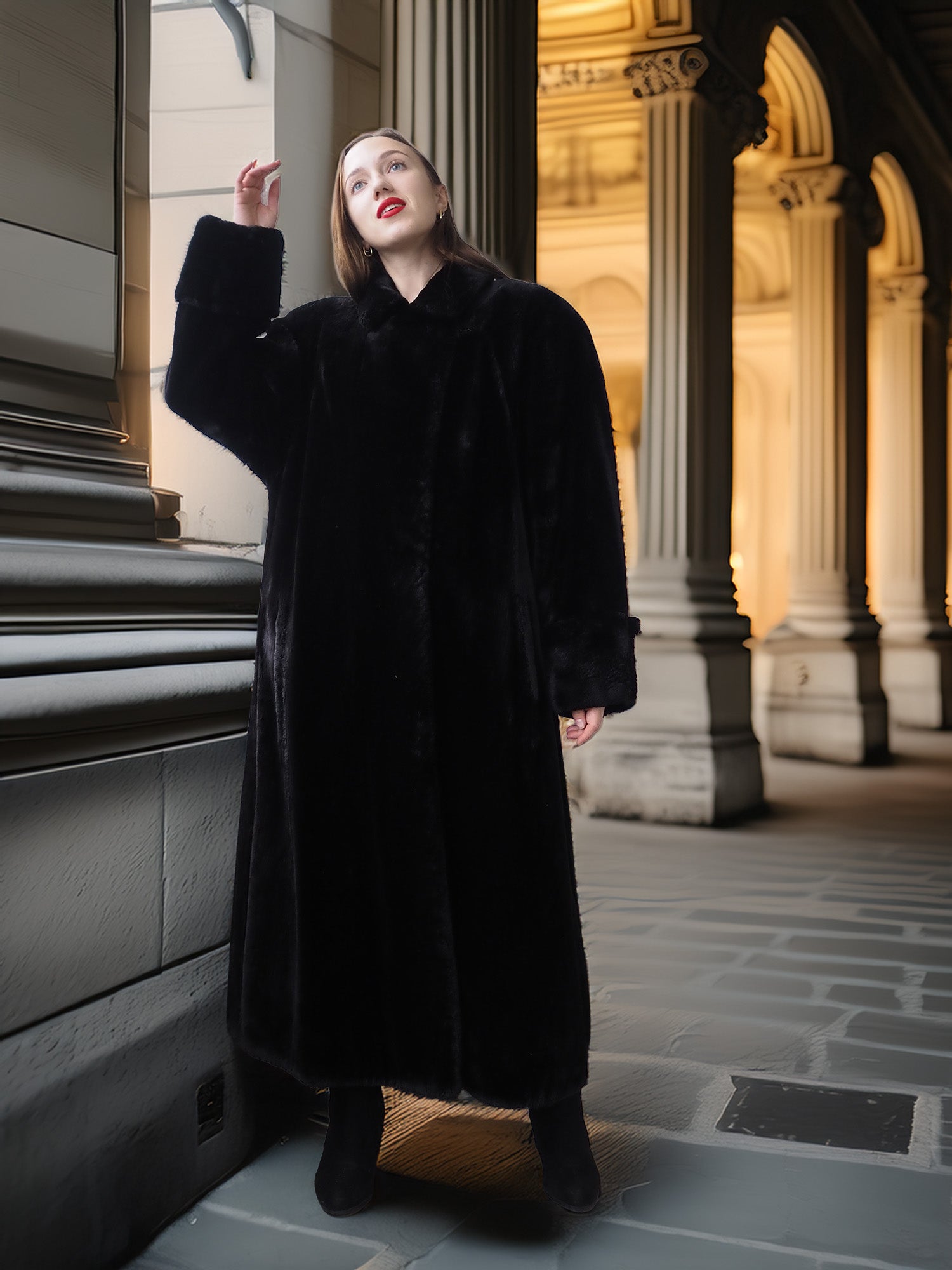 Woman wearing a long black coat standing in an architectural setting