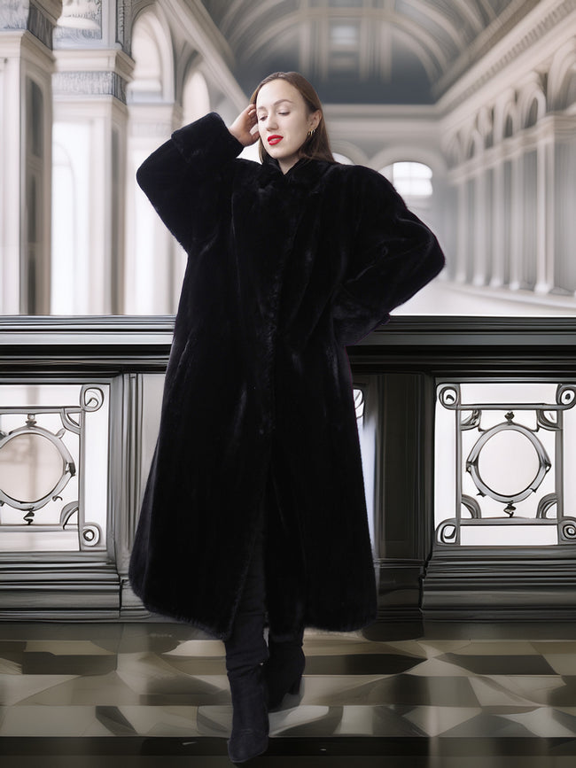 Woman wearing a black coat in an elegant interior setting
