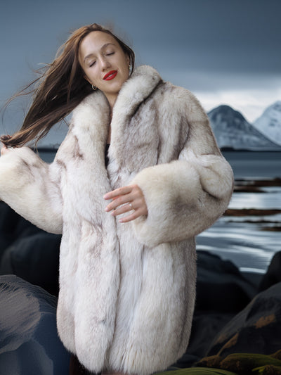 Woman wearing a fur coat with a snowy mountain landscape in the background