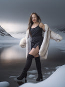 Woman in a fur coat standing in a snowy landscape