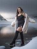 Woman in a fur coat standing in a snowy landscape