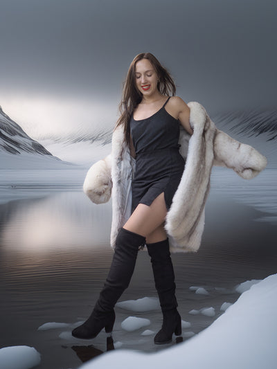 Woman in a fur coat standing in a snowy landscape