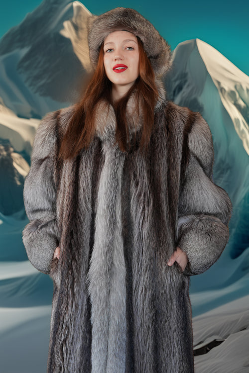 Woman wearing a fur coat with a mountainous background