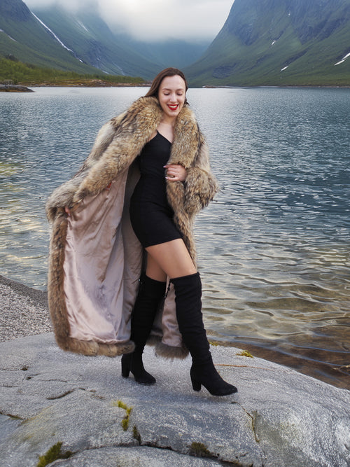 Open Finnish Raccoon Fur Coat revealing satin lining, paired with black mini dress and boots, styled for chic winter fashion.