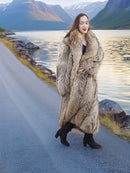 Model walking by lake in Finnish Raccoon Fur Coat with large shawl collar, styled for warm and elegant winter outerwear.