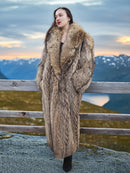 Elegant Finnish Raccoon Fur Coat with oversized shawl collar, worn in a highland landscape at sunset, perfect for winter outerwear.