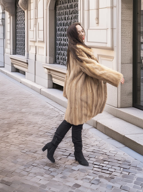 Golden Reverie M - Flowing mink coat in motion, highlighting its plush texture and elegant silhouette.