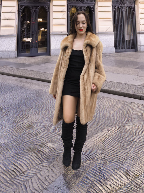 Golden Reverie M - Short blond mink coat with wide collar, styled with black dress for a chic outerwear ensemble.