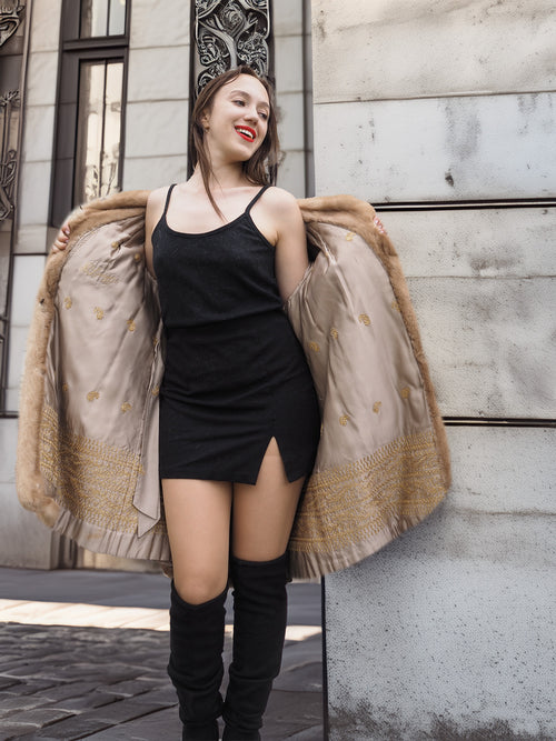 Golden Reverie M - Vintage Blond Mink Coat opened to reveal golden satin lining, paired with a black mini dress for chic contrast.