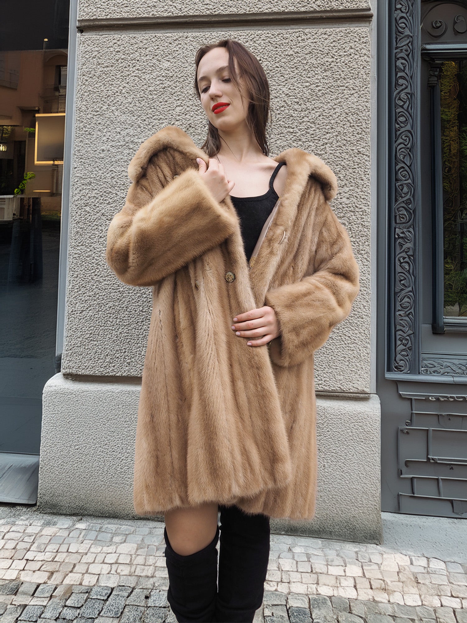 Golden Reverie M - Mink coat draped off shoulders, styled with black mini dress and boots for a bold fashion-forward look.