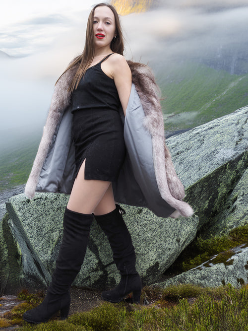 Brand new blue fox coat with satin lining and soft texture, worn open to reveal interior. Stylish fur jacket for upscale winter wardrobes.