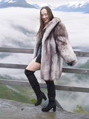 Plush blue fox fur coat with voluminous design and satin lining, worn on a foggy mountain deck. Elegant winter jacket in M/L size.