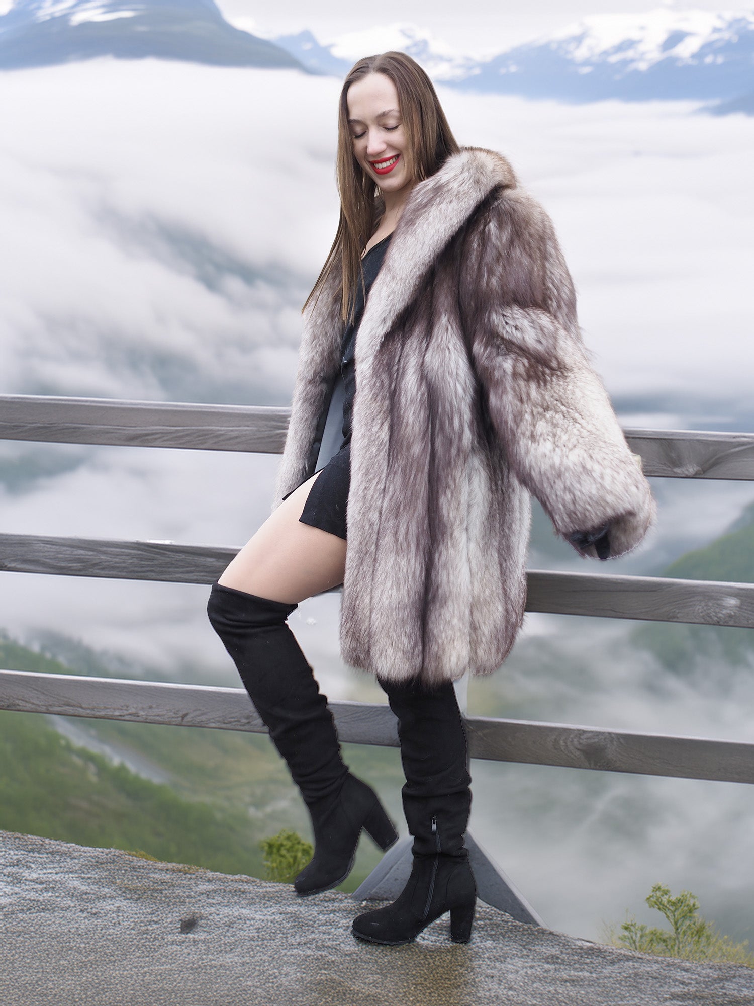 Plush blue fox fur coat with voluminous design and satin lining, worn on a foggy mountain deck. Elegant winter jacket in M/L size.