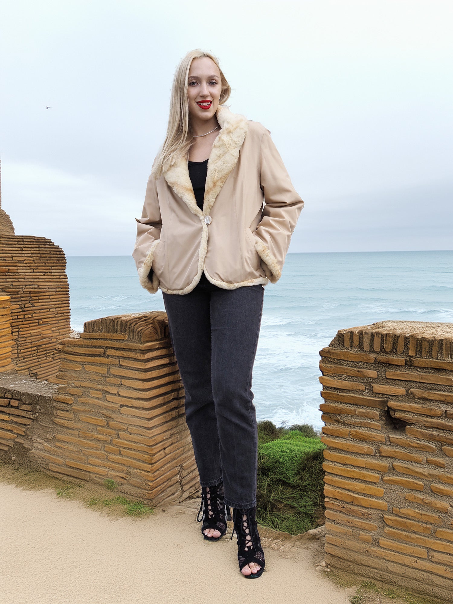 Reversible Versatile Sheared Mink Fur Jacket Coat S reversed to beige side, styled with black outfit near ocean ruins.