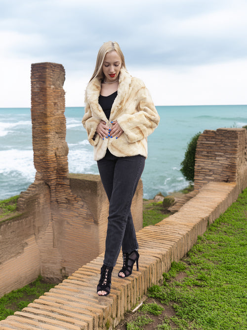 Reversible Versatile Sheared Mink Fur Jacket Coat S in light mink fur, modeled walking along brick wall with ocean view.