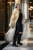 Golden island fox fur coat with wide lapels and long flowing hem; gray cuff trim