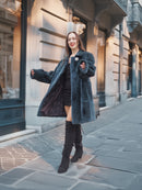 The Still Hour fur coat in deep teal styled open over a black outfit, combining vintage elegance with modern winter fashion.
