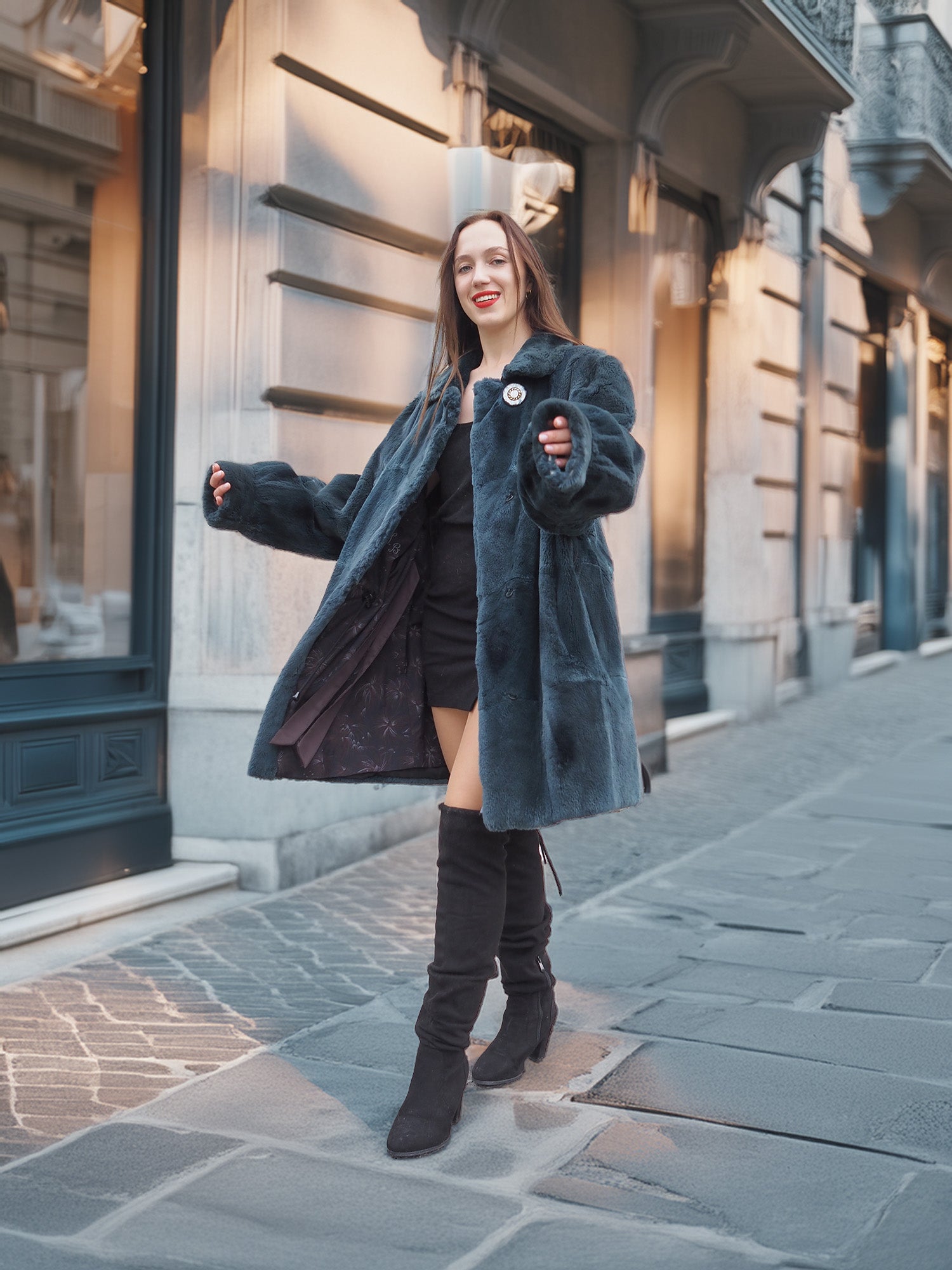 The Still Hour fur coat in deep teal styled open over a black outfit, combining vintage elegance with modern winter fashion.