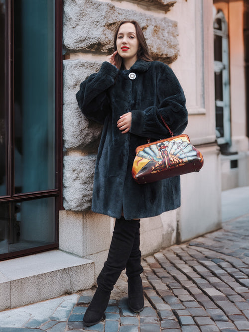 Vintage-inspired The Still Hour sheared muskrat fur coat in deep teal paired with black boots and a statement handbag, ideal for luxury fur fashion lovers.
