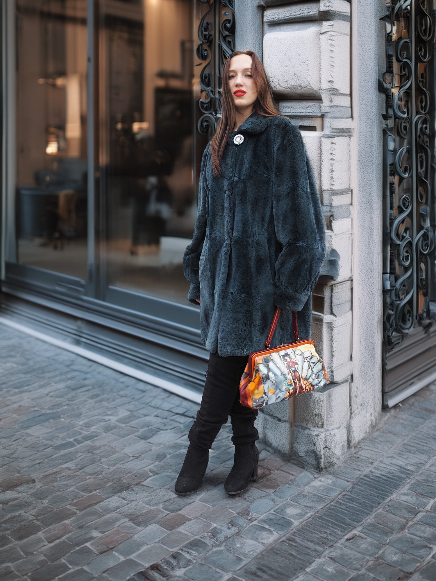 Chic and cozy, The Still Hour deep teal muskrat fur coat in M/L size styled with black suede boots for upscale winter outerwear appeal.