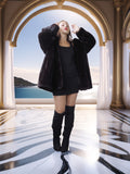 Woman in a black fur coat and boots standing in a luxurious room with a scenic view.