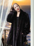 Woman wearing a black fur coat with a blurred background