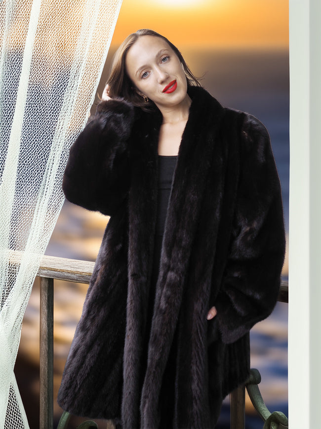 Woman wearing a black fur coat with a blurred background