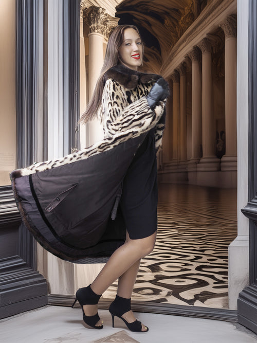 Woman in a stylish outfit with a black and leopard print dress in an elegant interior setting.