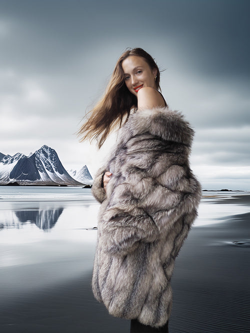 Woman wearing a fur coat with a mountainous landscape in the background