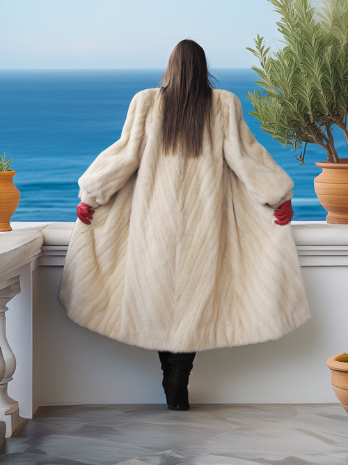 Person wearing a fur coat standing on a balcony with ocean view