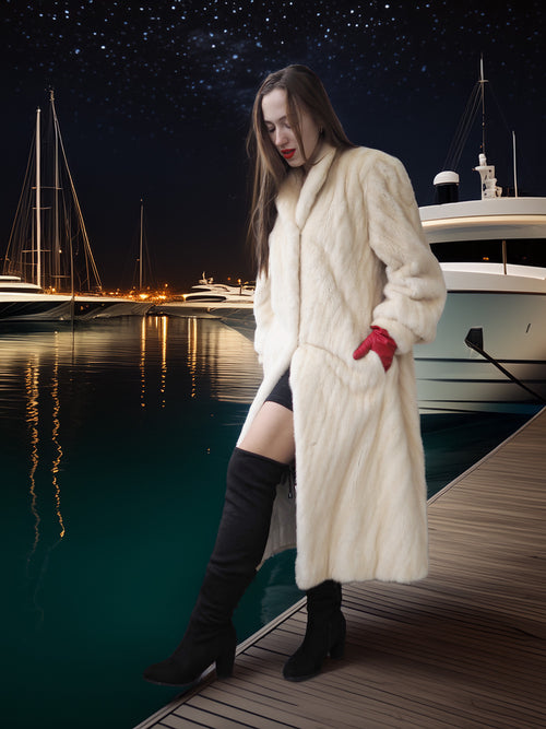 Woman in a fur coat standing on a dock with yachts in the background