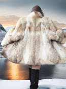Person wearing a fur coat with a mountainous landscape in the background