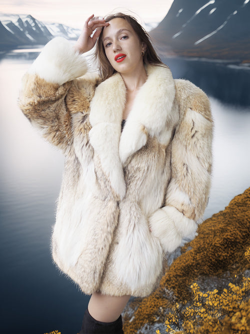 Woman wearing a fur coat with a scenic background