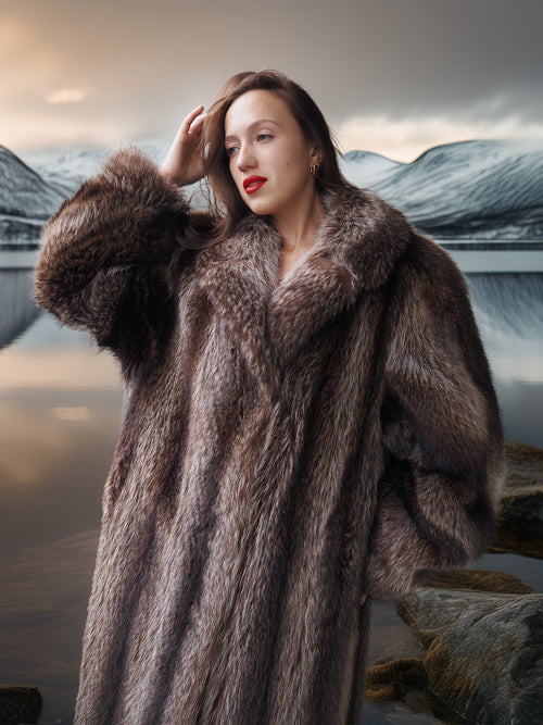 Woman wearing a fur coat with a scenic background