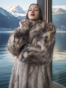 Woman wearing a fur coat with a mountainous landscape in the background