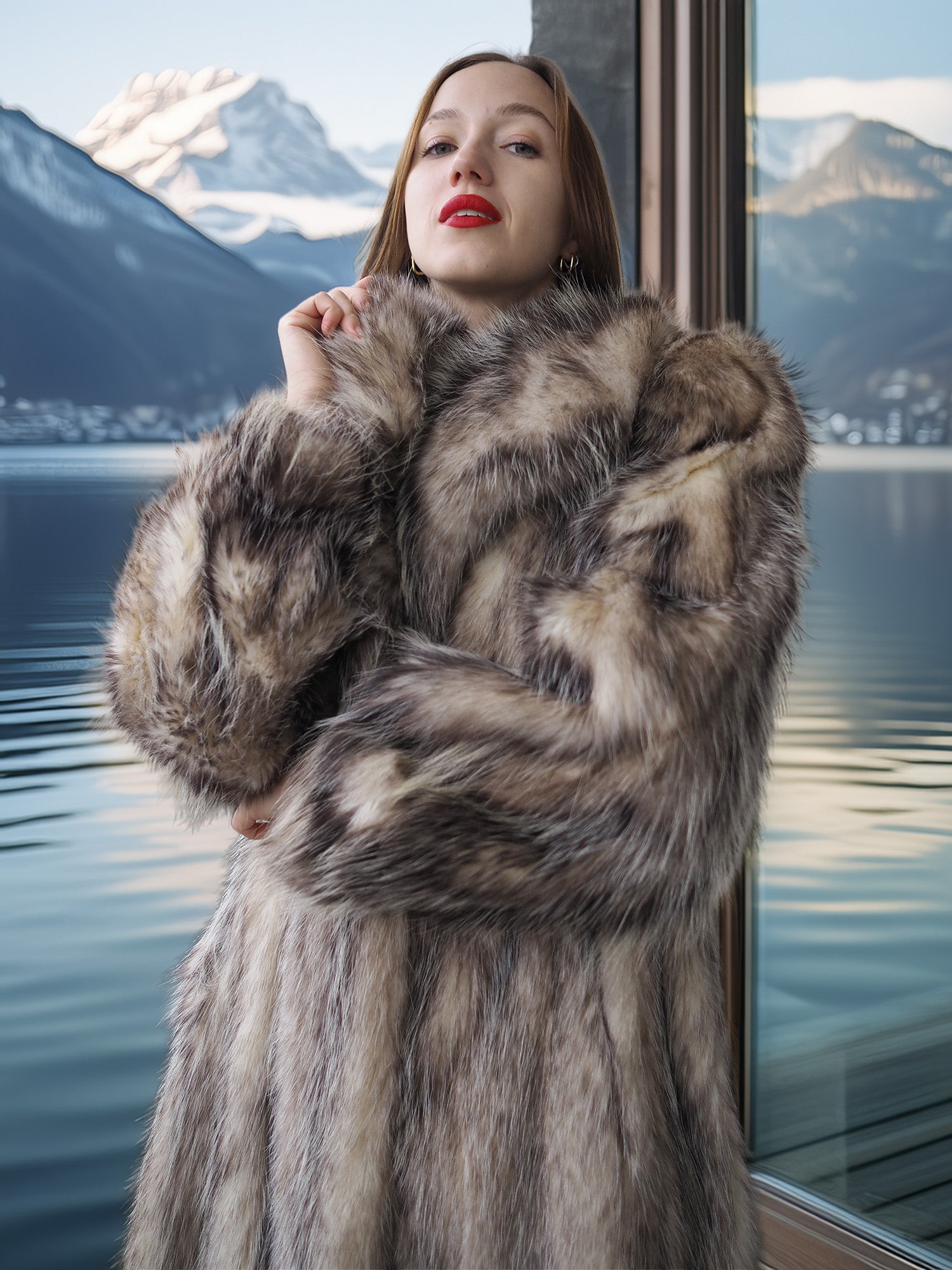 Woman wearing a fur coat with a mountainous landscape in the background