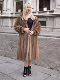 a woman in a fur coat standing on a sidewalk