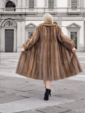 a woman in a fur coat is walking down the street