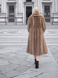 a woman in a fur coat is walking down the street