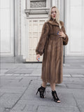 a woman in a fur coat standing on a sidewalk