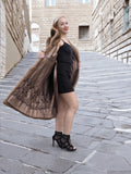 a woman is standing on a cobblestone street