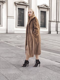 a woman in a fur coat standing on a sidewalk