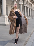 Elegant woman in vintage pastel mink fur coat posing in ornate architectural setting