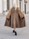 Luxurious vintage Canadian brown mink fur coat on display, showcasing its soft, warm, and voluminous design.